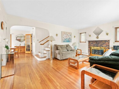 Living room, foyer, and opening to dining room