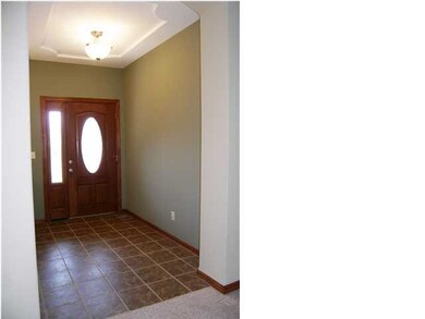 The spacious foyer features a coffered ceiling and