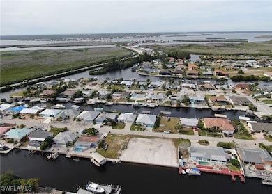 Aerial view featuring a water view and a residenti