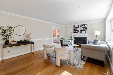 Living room with ornamental molding and light hard