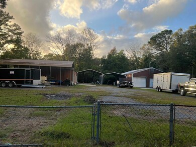 Yard at dusk with an outbuilding, a carport, and a
