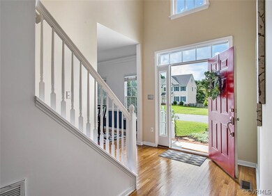 Two Story Foyer with hardwood floors