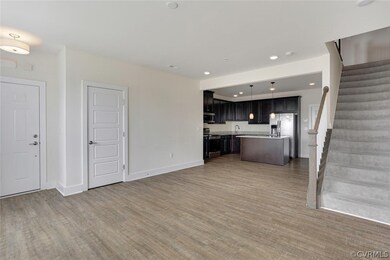 Unfurnished living room with sink and light wood-type flooring