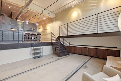 A wall of built-in cabinets provides plenty of storage. Up the stairs, a mezzanine leads to the deck.