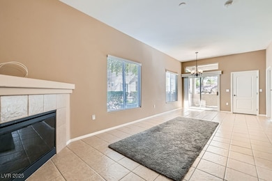 Living room with light tile patterned floors, a fi