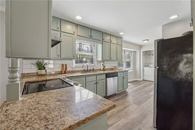 Kitchen with green cabinets, decorative backsplash