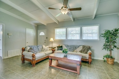 Living room with tile flooring and vaulted ceiling