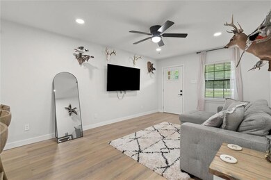 Living room with recessed lighting, ceiling fan, and light wood-type flooring