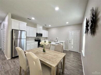 Dining area featuring dark wood-type flooring and recessed lighting