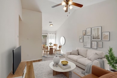 Living area with a ceiling fan, light wood finish