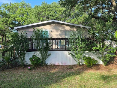 View of property exterior featuring a wooden deck
