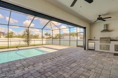 View of pool with area for grilling and ceiling fa