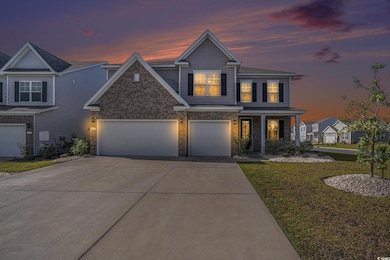 View of front facade featuring concrete driveway, a yard, brick siding, a porch, and a garage