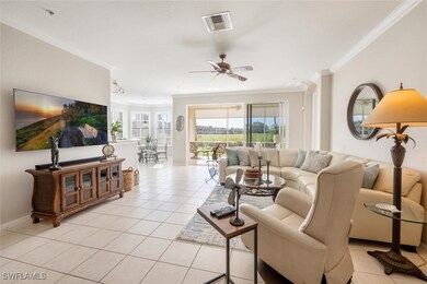 Living room featuring ceiling fan, ornamental mold