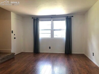 Spare room featuring wood-type flooring and basebo
