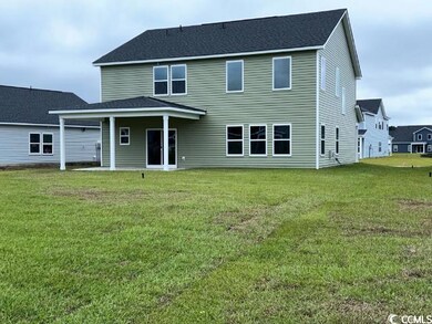 Rear view of house featuring a lawn