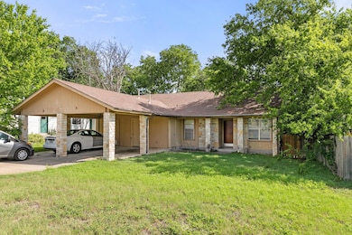 View of front of house with stone siding, a shing