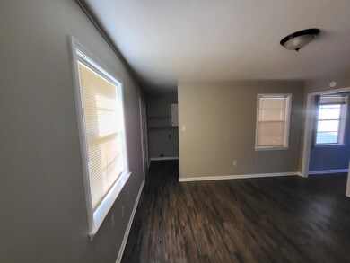 Spare room with dark hardwood / wood-style flooring