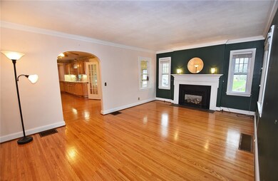 Spacious living room with gas fireplace and charming arched doorways