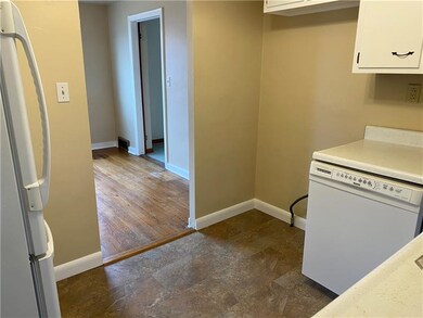 VIEW OF THE KITCHEN LOOKING INTO THE DINING ROOM.