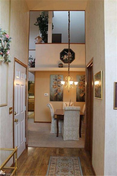 Foyer leads to two story great room/dining room