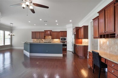 Kitchen with stainless steel appliances, visible vents, backsplash, a ceiling fan, and premium range hood