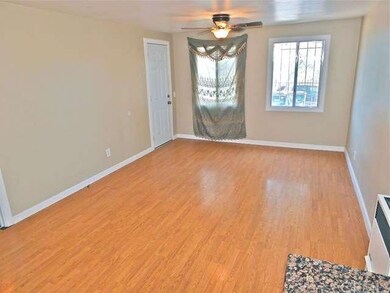 Spacious laminate wood flooring living room front 