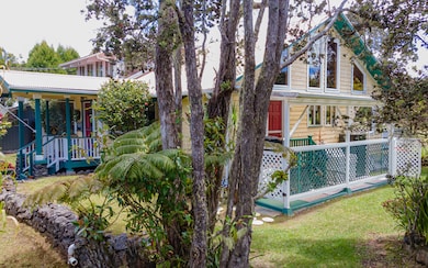 Surrounded by mature foliage, home sits back privately from street.