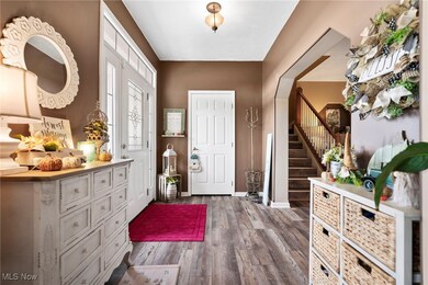 Foyer entrance featuring dark wood-style floors and stairs