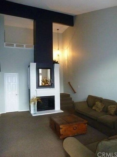 Living room with vaulted ceilings, and grand firep