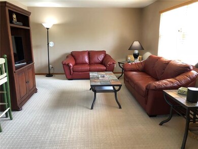 The spacious living room is painted in a neutral s