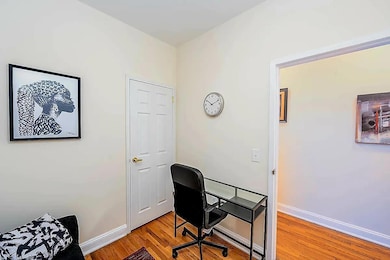 Office space with light wood-style floors and baseboards