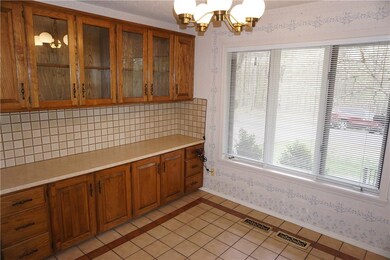 Eat in area of kitchen with cabinets and a view to