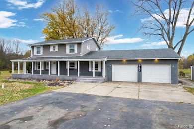 View of front of property with a porch, driveway, an attached garage, and a shingled roof