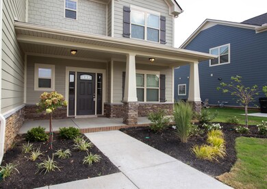 Charming and large front porch with fresh landscaping to enjoy while having your morning coffee. 