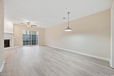 Unfurnished living room featuring baseboards, ceiling fan, light wood finished floors, visible vents, and a fireplace