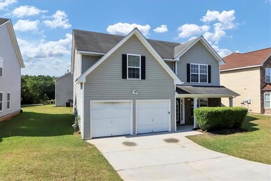 Front of property featuring a garage and a front l