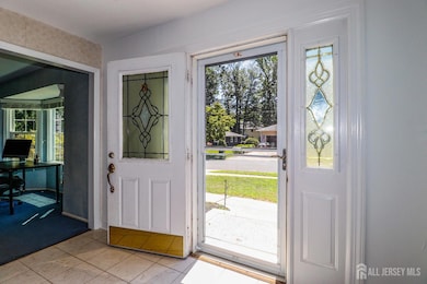 foyer entrance with plenty of natural light and light tile patterned floors