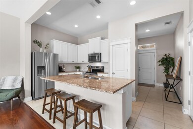 Kitchen featuring stainless steel appliances, lig