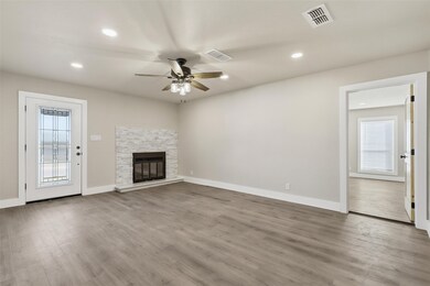 Unfurnished living room featuring wood finished floors, a fireplace, recessed lighting, and a ceiling fan