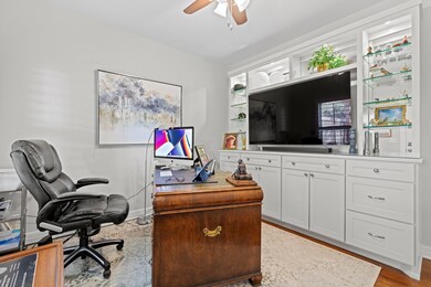 Office space featuring a ceiling fan and baseboar