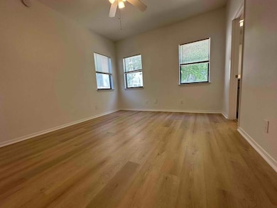 Unfurnished room with light wood-style floors, ba