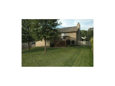 Large backyard with wood fence and mature trees