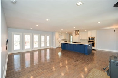 Open floor plan, hardwoods, recessed lighting