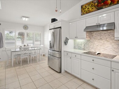 Kitchen with vaulted ceiling, hanging light fixtur