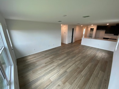 Unfurnished living room featuring light wood finis