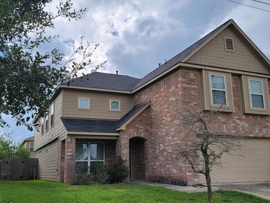 View of front of home with a front yard and a garage