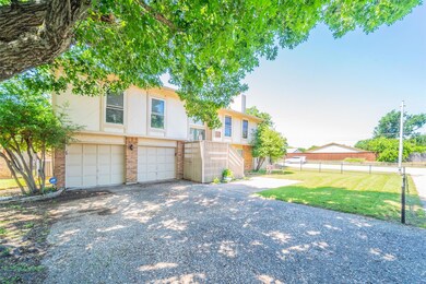 View of front of home with a front lawn and a garage