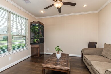 Study/office with double windows, manufactured wood flooring and ceiling fan.