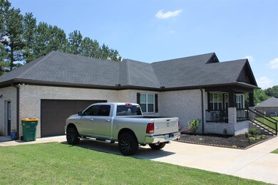 Large oversized 2 Car Garage w/Walk out Door; Concrete Driveway & Lots of Fresh Landscaping